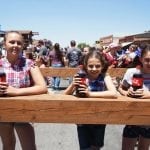 A trio of kids prepare for the soda drinking contest.