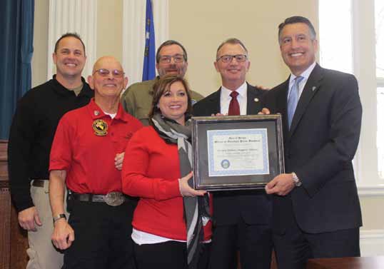 Steve Ranson
Teresa Di Loreto, center, executive director of the Nevada Military Support Alliance, accepts December’s Veteran Supporter of the Month award from Gov. Brian Sandoval. From left are NMSA directors John Brownell, Dick Gammick, Jon Yuspa and Dan Morgan.