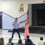CAPTION Juggler Dana Adams works with a student during a Red Ribbon Week assembly.