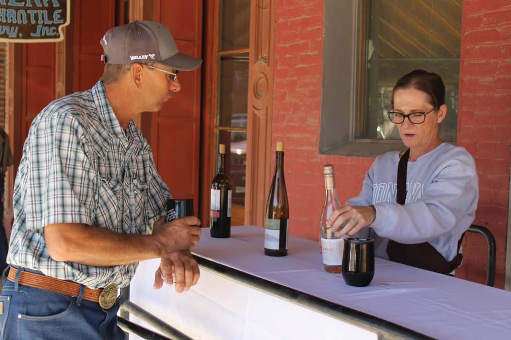 Tim Bailey learns about a wine at the 2026 Art, Wine and Music Fest on Sept. 19.